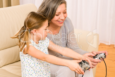 Grandmother and granddaughter play computer game