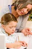 Grandmother help granddaughter doing homework