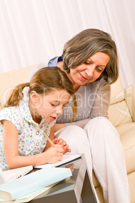 Grandmother help granddaughter doing homework