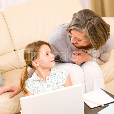 Grandmother with granddaughter use  computer
