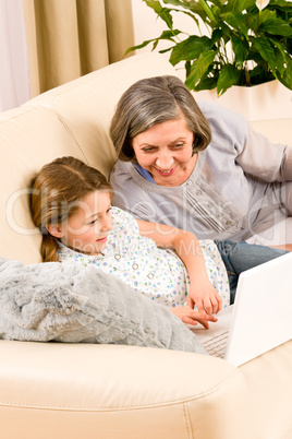 Grandmother with granddaughter use  computer