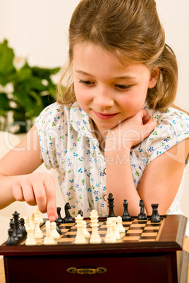 Young girl play chess cute smile