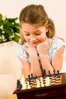 Young girl play chess cute smile