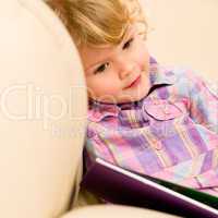 Little girl with book looking at pictures