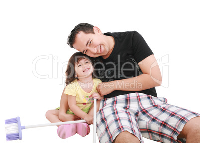 Father and daughter playing together and looking camera