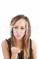 Portrait of a woman blowing a kiss against a white background