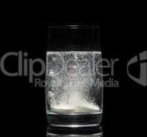 aspirin tablet in glass of water