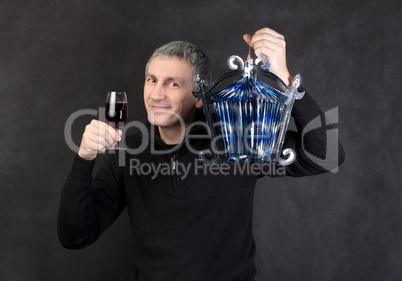 Man holding a glass wine and lantern