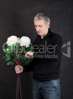 Man holding a bouquet of flowers