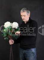 Man holding a bouquet of flowers