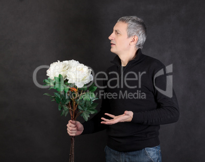 Man holding a bouquet of flowers