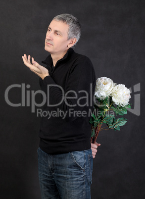 Man hiding a bouquet of flowers