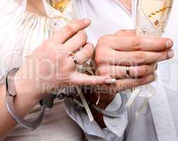 Wedding. Hands in handcuffs newlyweds