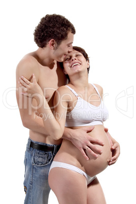 Young man with his pregnant wife on the white background