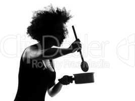 young afro american woman silhouette cooking