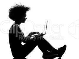 young afro american woman silhouette siting on floor computing l