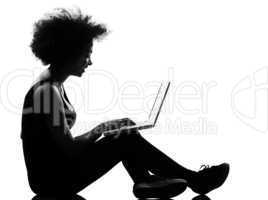 young afro american serious woman silhouette siting on floor com