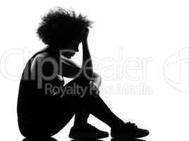 young afro american woman silhouette sit on the floor sadness