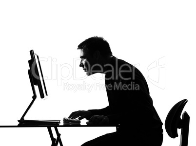 silhouette  man  computing staring at the monir