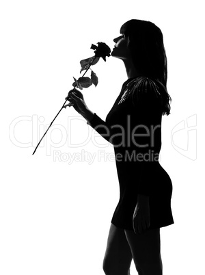 stylish silhouette woman smelling a flower rose