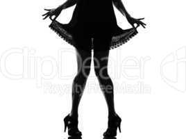 stylish silhouette woman legs pulling her summer dress