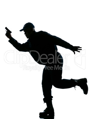 Silhouetted police man running with a handgun