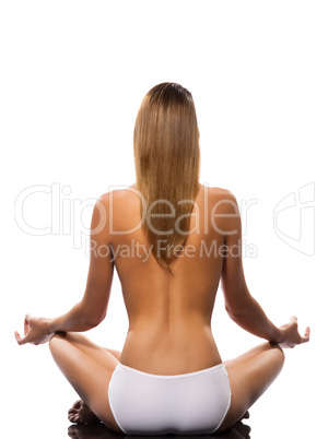 Topless woman meditating