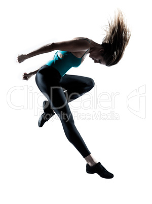 Young female doing gymnastic jump studio