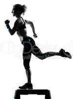 woman exercising step aerobics.
