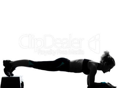 woman exercising step aerobics push ups.