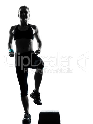 woman exercising step aerobics.