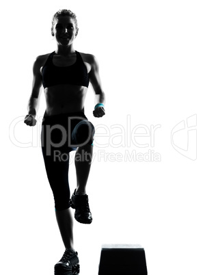 woman exercising step aerobics.