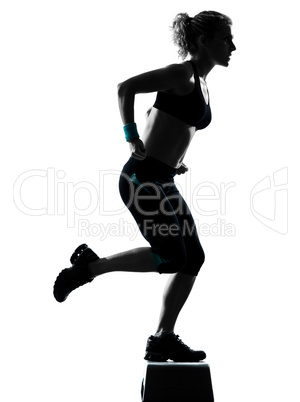 woman exercising step aerobics.