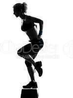 woman exercising step aerobics.