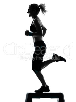 woman exercising step aerobics.