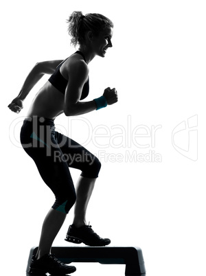 woman exercising step aerobics.