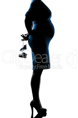 pregnant woman holding baby shoes