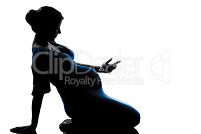 pregnant woman sitting holding babby bottle