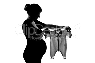 one pregnant woman holding baby clothes