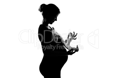 pregnant woman holding baby clothes