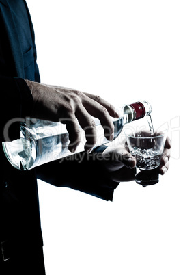 silhouette man hands close up pouring white alcohol