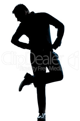 silhouette man full length looking at his shoes