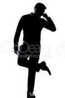 silhouette man full length looking at his shoes with unpleasant