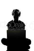 one young teenager boy or girl silhouette computer computing lap