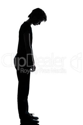 one young teenager boy or girl sad looking down silhouette