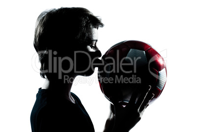 one young teenager boy or girl silhouette kissing soccer footbal