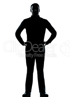 one business man standing hands on hips silhouette