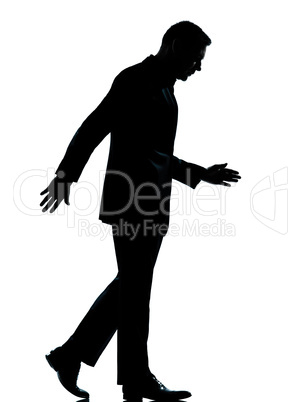 one business man walking looking down silhouette