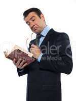 Man teacher reading holding old book thinking