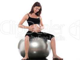 Pregnant Woman Happy sitting on swiss ball fitness